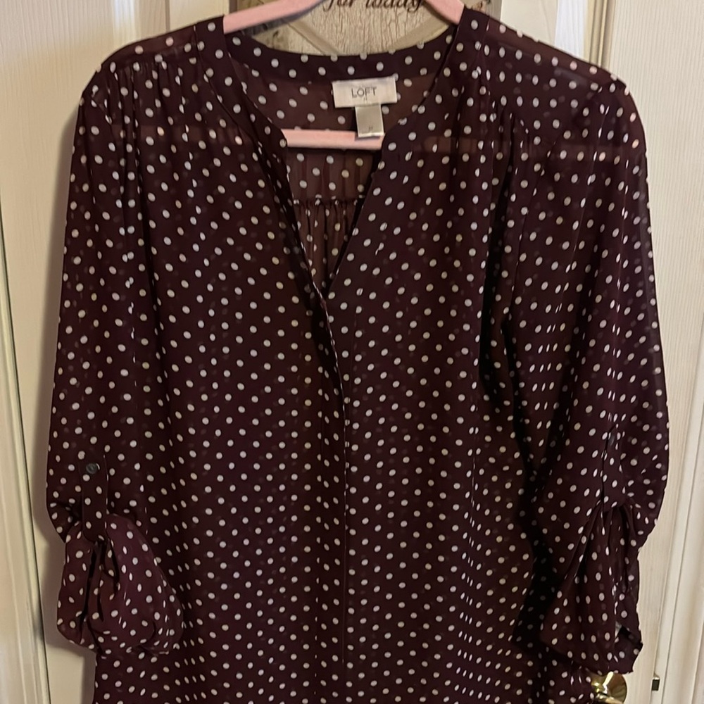 Long-sleeved Sheer Loft polka dot blouse with roll up sleeves.